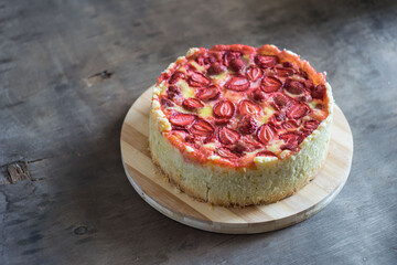 Baked strawberry pie cake tart on rustic wooden table. Selective focus
