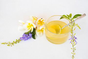 herbal healthy drinks honey lemon health care for cough sore with flowers frangipani arrangement flat lay style on background wooden white