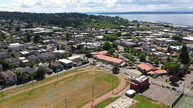 Cinematic 4K drone trucking footage of the downtown Edmonds commercial area, Kingston ferry terminal waterfront marina, near Seattle in Western Washington, Pacific Northwest, in Snohomish County