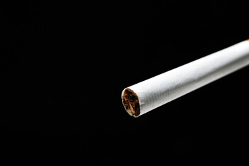 Cigarette on dark background, closeup