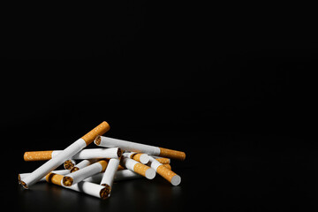 Many cigarettes on dark background