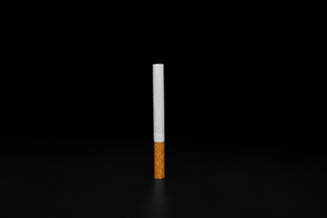 Cigarette on dark background. Concept of bad habit
