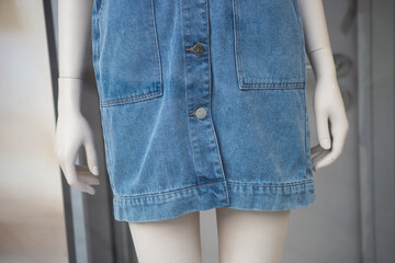 Fototapeta na wymiar Closeup of blue jeans dress on mannequin in a fashion store showroom