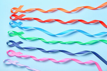 Different awareness ribbons on color background