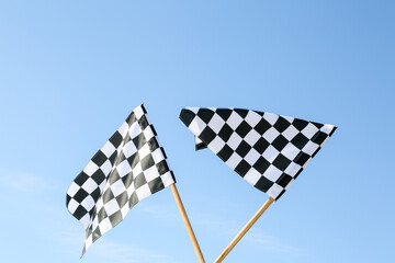 Racing flags against blue sky