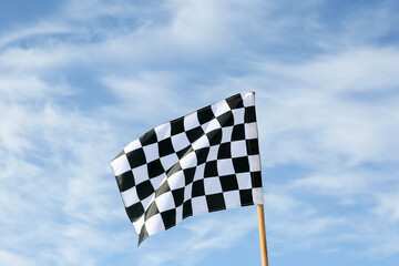 Racing flag against blue sky