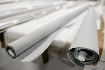 Rolls of textile for roller blinds in a factory
