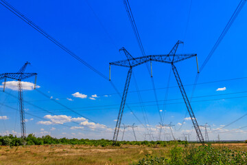 High voltage power line against blue sky