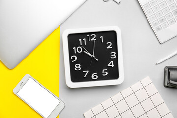 Composition with stylish clock and gadgets on color background