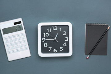 Composition with stylish clock and calculator on grey background