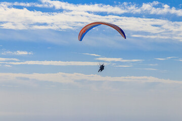 Paragliders in blue sky. Concept of active lifestyle and extreme sport adventure