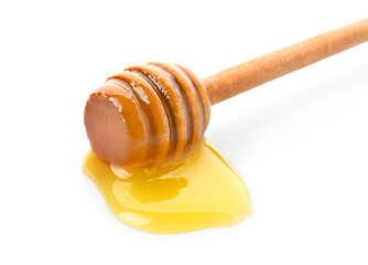 Wooden dipper with honey on white background