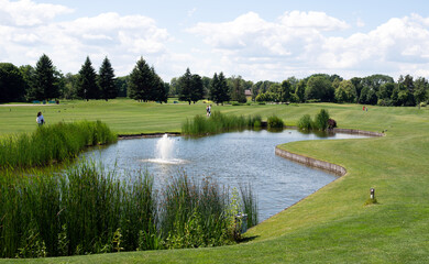 Beautiful of golf club with pond and perfect green lawn and grass