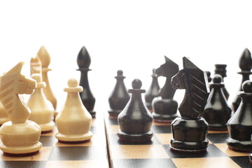 Wood chess pieces on a board isolated white background