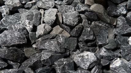 Closeup Pile of Crushed grey stone charcoal color or road metal texture background with natural...