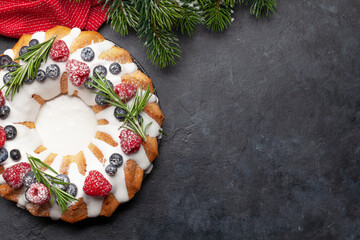Christmas cake with berries and fir tree