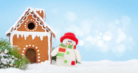 Christmas greeting card with gingerbread house, fir tree and snowman