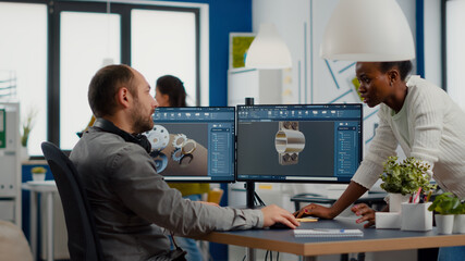 Industrial engineer and african project manager working on 3D construction metalic components in...