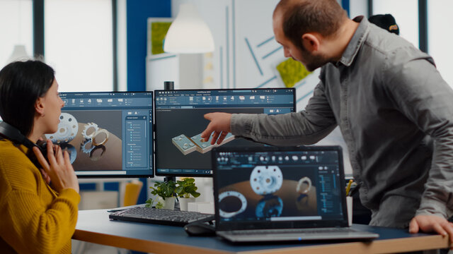 Industrial Development Engineer Analysing And Sharing Ideas With Project Manager Working On Computer. Team Of Professionals Using CAD Software For Modern Industrial Engineering Design.
