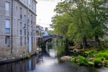 Fototapeta na wymiar Medieval stone bridge over the Aronia river, Baños de Molgas, in the province of Ourense, Galicia (Spain)