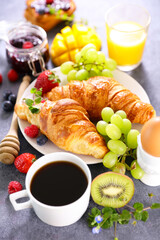 croissant with coffee cup and fresh fruits