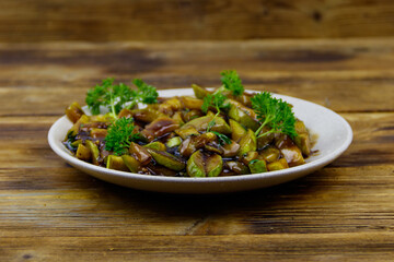 Tasty marrows in soy sauce on wooden table