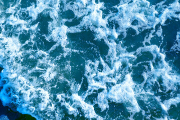 Deep blue and rough sea with lot of sea spray.Blue background.Soft focus,blurred image.