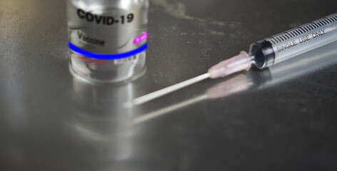 Close up of Syringe  with Coronavirus vaccine.Some ampoules with ncov-2019.