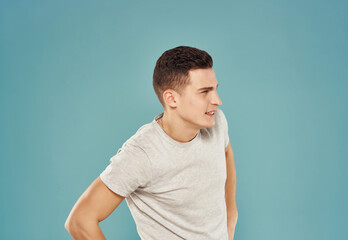 handsome man in t-shirt gesturing with his hands cropped view blue background