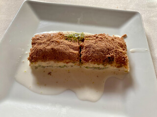 Cold Baklava. Traditional Turkish Delight Dessert with Chocolate Cocoa Powder and Milk.