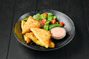 Sandwich with cheddar and salad on a plate