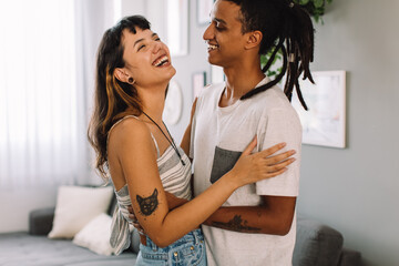 Carefree young couple flirting at home