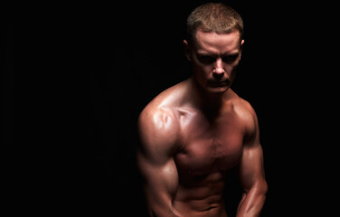 Fototapeta na wymiar bodybuilder in dark. strong Boy. Naked body muscular Man