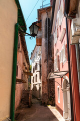 Fototapeta na wymiar Narrow street of ancient Lovran town on Adriatic coast, Croatia
