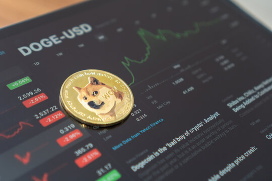 Bangkok, Thailand - June 16, 2021: Dogecoin Doge coin cryptocurrency, digital crypto currency tokens for defi decentralized financial banking p2p global investment financial business stock market