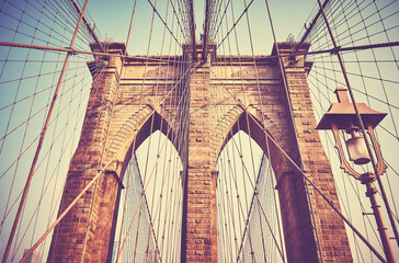 Retro stylized picture of Brooklyn Bridge with street lamp, New York City, USA.