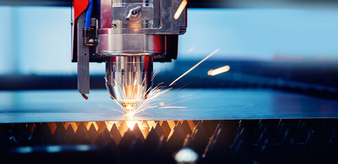 Blue color Laser CNC cut of metal with light spark, technology modern industrial banner