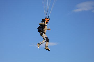 Fototapeta na wymiar Skydiving. A skydiver is landing.