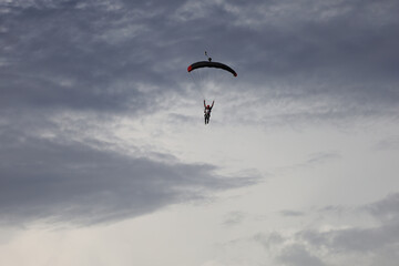Skydiving. Cloudy sky and a parachute in the sky.