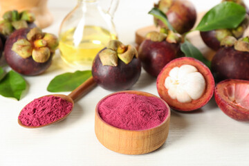 Purple mangosteen powder and fruits on white table