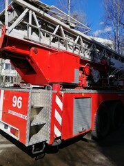 a big red Russian fire truck in the city courtyard with the inscription "Vsevolozhsk" on a sunny spring day