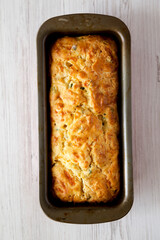 Homemade Cheesy Bread Loaf on a white wooden background, top view. Flat lay, overhead, from above.