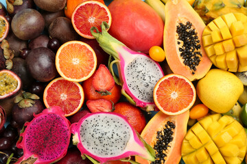 Many different delicious exotic fruits as background, top view