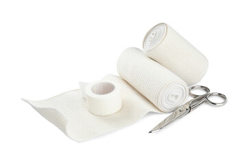 Medical bandage rolls, sticking plaster and scissors on white background