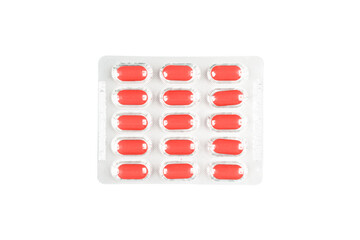 Macro shot pile of red tablets pill in blister packaging isolated on white background. Aluminium...