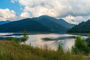 Fototapeta na wymiar Gura Apelor lake with hills on the background in Romania