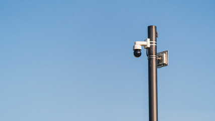 A modern wide-angle CCTV camera on a pole