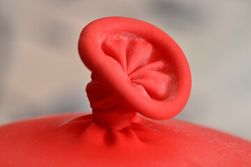 Closeup shot of a red balloon knot for wallpaper and background