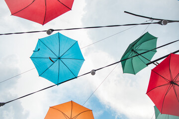 Colorful umbrellas in the sky. Multicolored umbrellas in the sky, creating a summer, art mood on the street