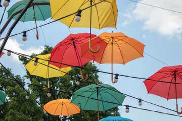 Colorful umbrellas in the sky. Multicolored umbrellas in the sky, creating a summer, art mood on the street